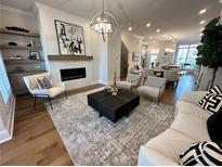 Spacious living room featuring hardwood floors, a fireplace, and large windows at 3167 Moor View Rd # 35, Duluth, GA 30096