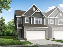 Two-story townhome with gray siding, white garage door, and landscaping at 711 Smokey Quartz Way, Kennesaw, GA 30144