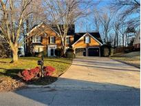 Brick two-story house with a two-car garage and landscaped yard at 3281 Allegheny Dr, Marietta, GA 30066