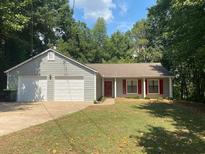 Ranch home with attached two-car garage and landscaped lawn at 1914 Grant Ln, Woodstock, GA 30188