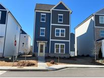Three-story home with gray siding and a light-colored front door at 1366 Creekside Nw Cir, Atlanta, GA 30318
