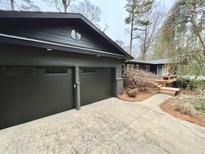 Dark gray two-car garage with stamped concrete driveway at 1389 Dogwood Se Cir, Smyrna, GA 30080