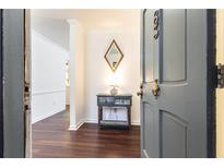 Inviting entryway with wood floors and decorative console table at 83 Chaumont Nw Sq, Atlanta, GA 30327