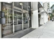 Modern building entrance with glass doors and The Metropolitan signage at 20 Marietta Nw St # 6F, Atlanta, GA 30303