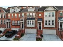 Brick townhouses with attached garages and steps leading to the front entrances at 2782 Loftview Sq # 1, Atlanta, GA 30339