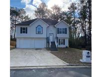 Charming split-level home with a two-car garage and inviting front entrance at 5619 Mayfair Crossing Dr, Lithonia, GA 30038