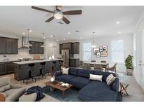 Open living room and kitchen with island, stainless steel appliances, and seating at 548 Sawnee Village Blvd # D72, Cumming, GA 30040