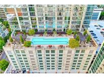 Resort-style rooftop pool with city views, lush landscaping, and comfortable seating at 855 Peachtree Ne St # 2307, Atlanta, GA 30308