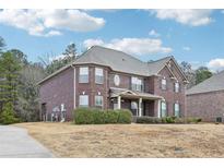 Brick two-story house with landscaping and a driveway at 189 Aylesbury Blvd, Mcdonough, GA 30252