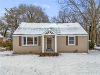 Charming ranch home with snow-covered lawn and updated exterior at 2003 Cogar Dr, Decatur, GA 30032