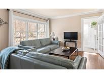 Cozy living room featuring hardwood floors, comfy sofas, and a large window at 4032 Eula Cir, Atlanta, GA 30360