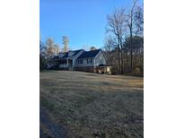 Ranch style home with large yard and covered porch at 2006 Goode Rd, Conyers, GA 30094