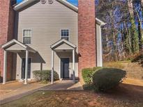 Tan two-story townhome with brick chimney and small front yard at 5431 Village Green Sq # 1018, Norcross, GA 30093