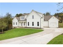 Two-story farmhouse with white siding, gray roof, and a long driveway at 113 Creekview Ln, Canton, GA 30115