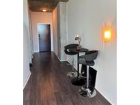 Modern entryway with dark hardwood floors and a small table and chairs at 3324 Peachtree Ne Rd # 1206, Atlanta, GA 30326