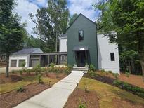 Stunning modern farmhouse with a lush landscaped front yard and walkway at 135 Cedarwood Ln, Roswell, GA 30075