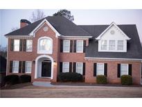 Two-story brick home with a gray roof, white accents, and black shutters at 2815 Shoemaker Ln, Snellville, GA 30039