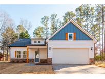 White house with blue accents and a two-car garage at 30 Sportsman Path, Dallas, GA 30157