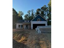 Newly constructed home with white siding, blue accents, and a two-car garage at 30 Sportsman Path, Dallas, GA 30157