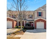 Inviting townhouse showcasing well-maintained landscaping, brick accents, and attached single-car garages at 168 Ellis Dr, Conyers, GA 30012