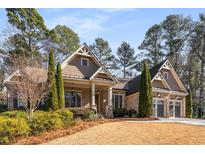 Brick home with a three-car garage and nicely landscaped yard at 5905 Kayron Dr, Atlanta, GA 30328