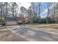 Ranch home with attached garage and mature trees at 110 Wiley Bridge Ct, Woodstock, GA 30188