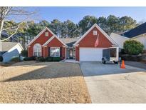 Brick ranch home with attached garage and American flag at 436 Suwanee East Dr, Lawrenceville, GA 30043