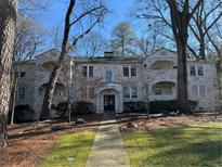 Brick front of charming home with mature trees and landscaped yard at 51 Peachtree Memorial Nw Dr # 4, Atlanta, GA 30309