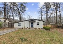 Charming single story home featuring a well-kept lawn and stylish painted brick at 883 Verona Dr, Clarkston, GA 30021