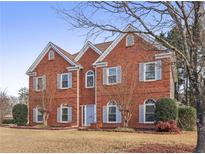 Brick house with gray shutters, landscaping, and a large front yard at 1085 Grace Hadaway Ln, Lawrenceville, GA 30043