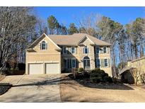 Two-story house with stone accents, shutters, and a two-car garage at 308 Hillpine Dr, Woodstock, GA 30189