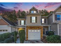 Two-story townhome with stone accents and a two-car garage at 228 Ridge Mill Dr, Acworth, GA 30102