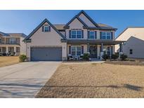 Two-story brick home with gray accents and a landscaped lawn at 5330 Austrian Pine Ct, Cumming, GA 30040