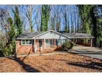 Brick ranch house with carport and mature trees in front yard at 2364 Oakridge Ct, Decatur, GA 30032