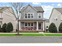 Gray two-story home with red chairs on front porch at 164 Goshen Ln, Woodstock, GA 30188