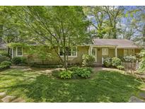 Charming ranch home with mature landscaping and brick pathway at 4750 Rebel Trl, Atlanta, GA 30327