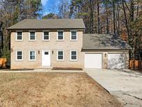 Two-story house with a two-car garage and well-maintained lawn at 4925 Erin Rd, Atlanta, GA 30331