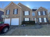 Brick two-story house with a two-car garage and a basketball goal at 5993 Springfair Run, Lithonia, GA 30038