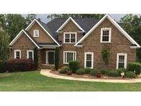 Brick two-story house with landscaped yard and walkway at 7801 Windswept Way, Douglasville, GA 30135