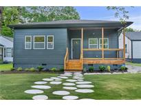 Charming single-story home featuring a welcoming front porch, stone walkway, and beautifully landscaped front yard at 639 Ozburn, Atlanta, GA 30318