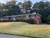 Brick ranch home on a spacious lot with mature trees and landscaping at 363 Seminole Ne Dr, Marietta, GA 30060