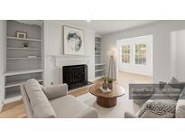 Bright living room with fireplace, built-in bookshelves, and neutral decor offers a cozy and inviting atmosphere at 2042 Brian Way, Decatur, GA 30033