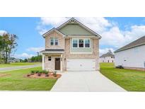 Two-story brick home with a two-car garage and landscaped lawn at 75 Barge Ln, Covington, GA 30016