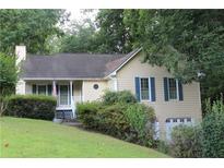 Charming ranch home with mature landscaping and a two-car garage at 410 Raven Dr, Canton, GA 30115