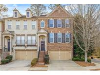 Inviting brick townhome featuring an attached garage and manicured landscaping in a desirable community at 2827 Overlook Ne Trce, Atlanta, GA 30324