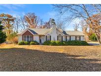 One-story house with brick accents and a spacious yard at 341 Harris Ave, Locust Grove, GA 30248