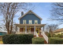 Charming two-story home with a wrap-around porch and well-manicured landscaping at 107 Watson Se Cir, Atlanta, GA 30317