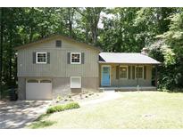 Ranch home with attached garage, blue door, and landscaped yard at 34 Timber Chase Dr, Dallas, GA 30157