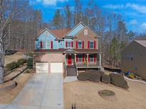 Two-story brick home with blue siding, red shutters, and a front porch at 753 Win West Xing, Auburn, GA 30011