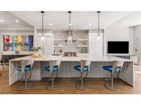 Bright kitchen featuring a large waterfall island, pendant lighting, and stainless steel appliances at 902 Lenox Ne Blvd, Atlanta, GA 30324